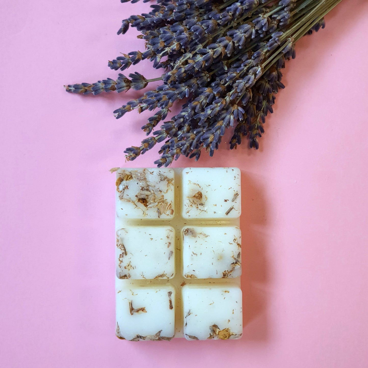 Lavender and lemon soy wax melts adorned with dried lavender and chamomile herbs. The wax melt emits a soothing aroma, while the herbs add a natural touch of beauty and relaxation.