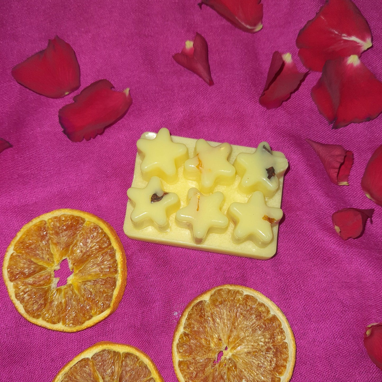 Capturing the essence of festive warmth, our Winter Bliss Soy Wax Melt is showcased against a sensual pink backdrop. The soy wax melts are artfully arranged, embraced by the natural beauty of sliced oranges and star anise. A sensory celebration of the season, inviting coziness and holiday cheer.