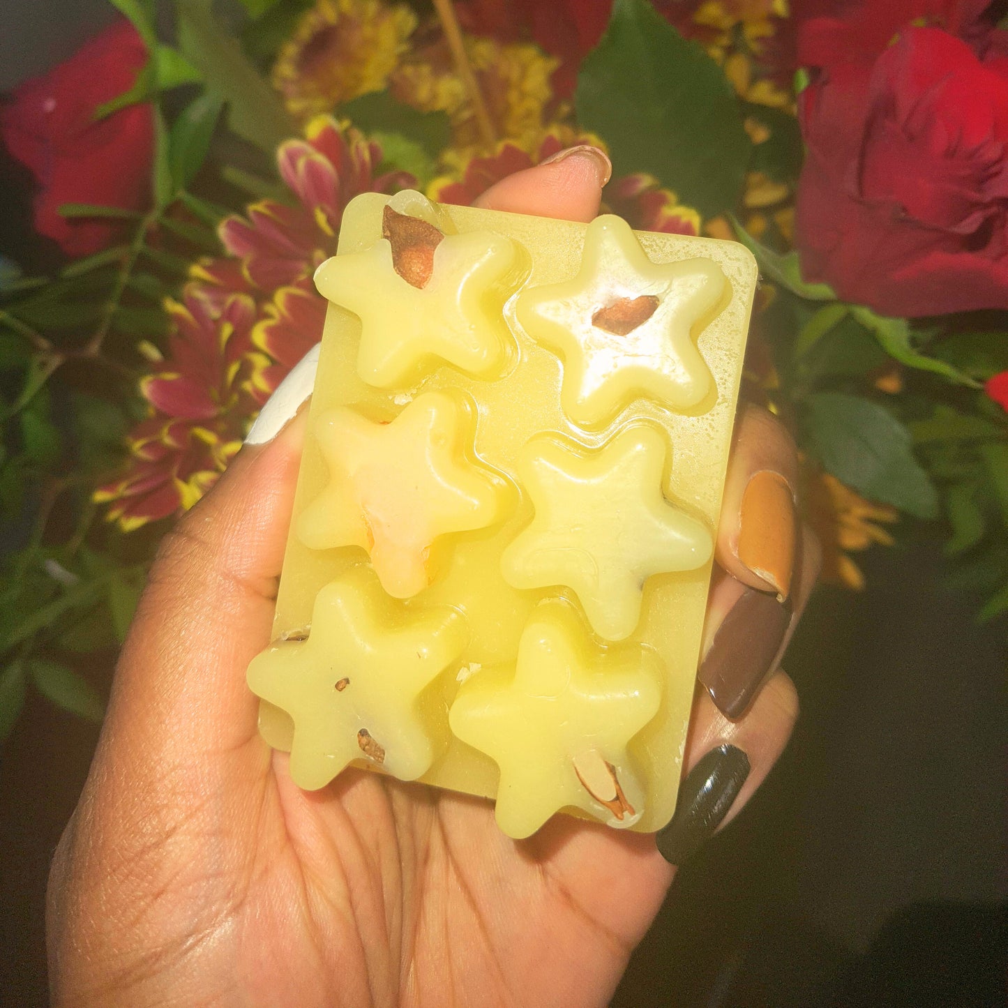 Embrace the holiday spirit with our Winter Bliss Soy Wax Melt, delicately held in hand against a backdrop of festive red flowers. The soy wax melds seamlessly with the season's vibrancy, creating a sensory symphony that ignites the joy of winter.