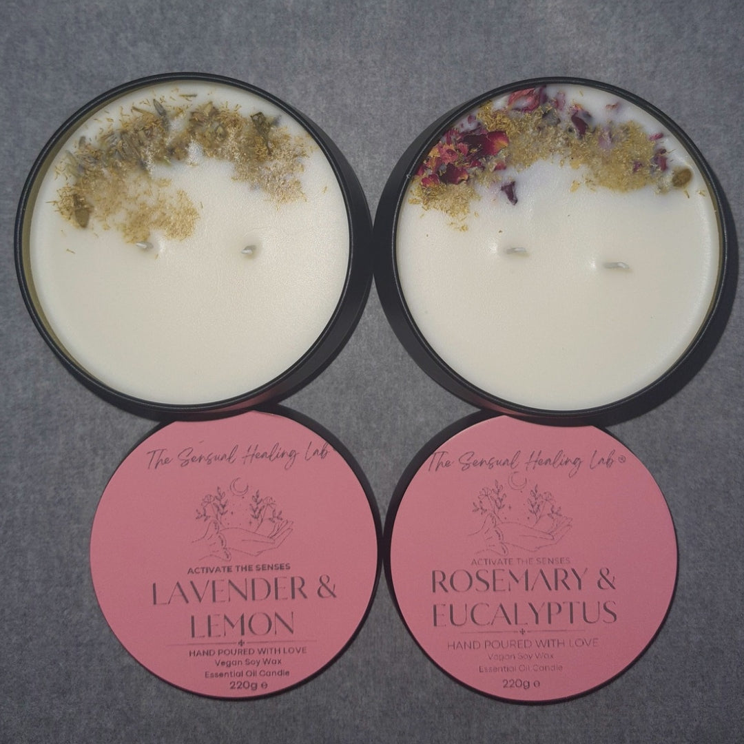 Two candles handmade soy wax candle with decorative elements on lids and pink labels on a gray background