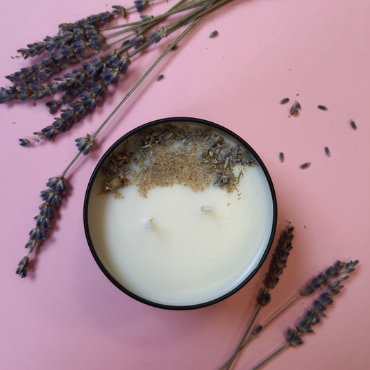 Lavender and lemon soy wax candle adorned with dried lavender and chamomile herbs. The candle emits a soothing aroma, while the herbs add a natural touch of beauty and relaxation.