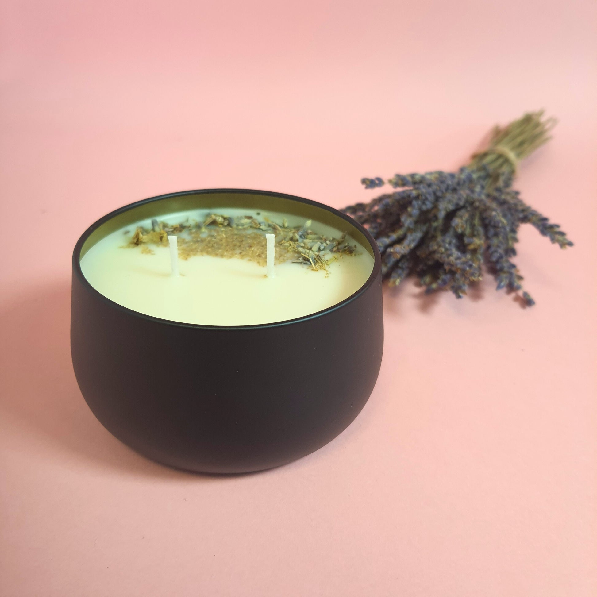 Lavender and lemon soy wax candle adorned with dried lavender and chamomile herbs. The candle emits a soothing aroma, while the herbs add a natural touch of beauty and relaxation.