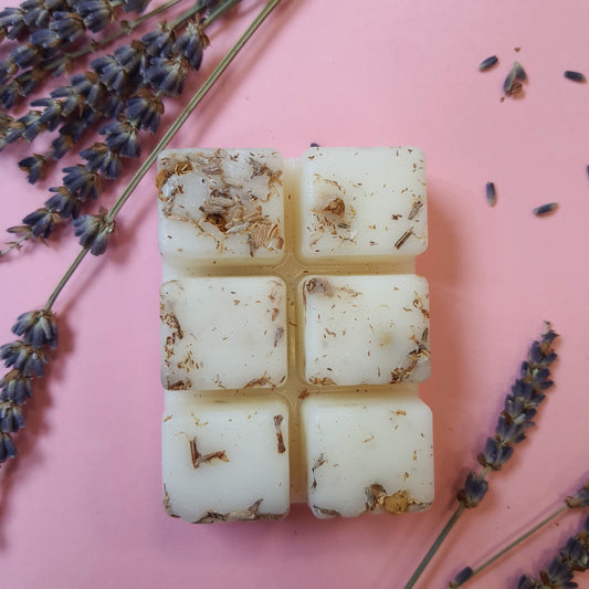 Lavender and lemon soy wax melts adorned with dried lavender and chamomile herbs. The wax melt emits a soothing aroma, while the herbs add a natural touch of beauty and relaxation.